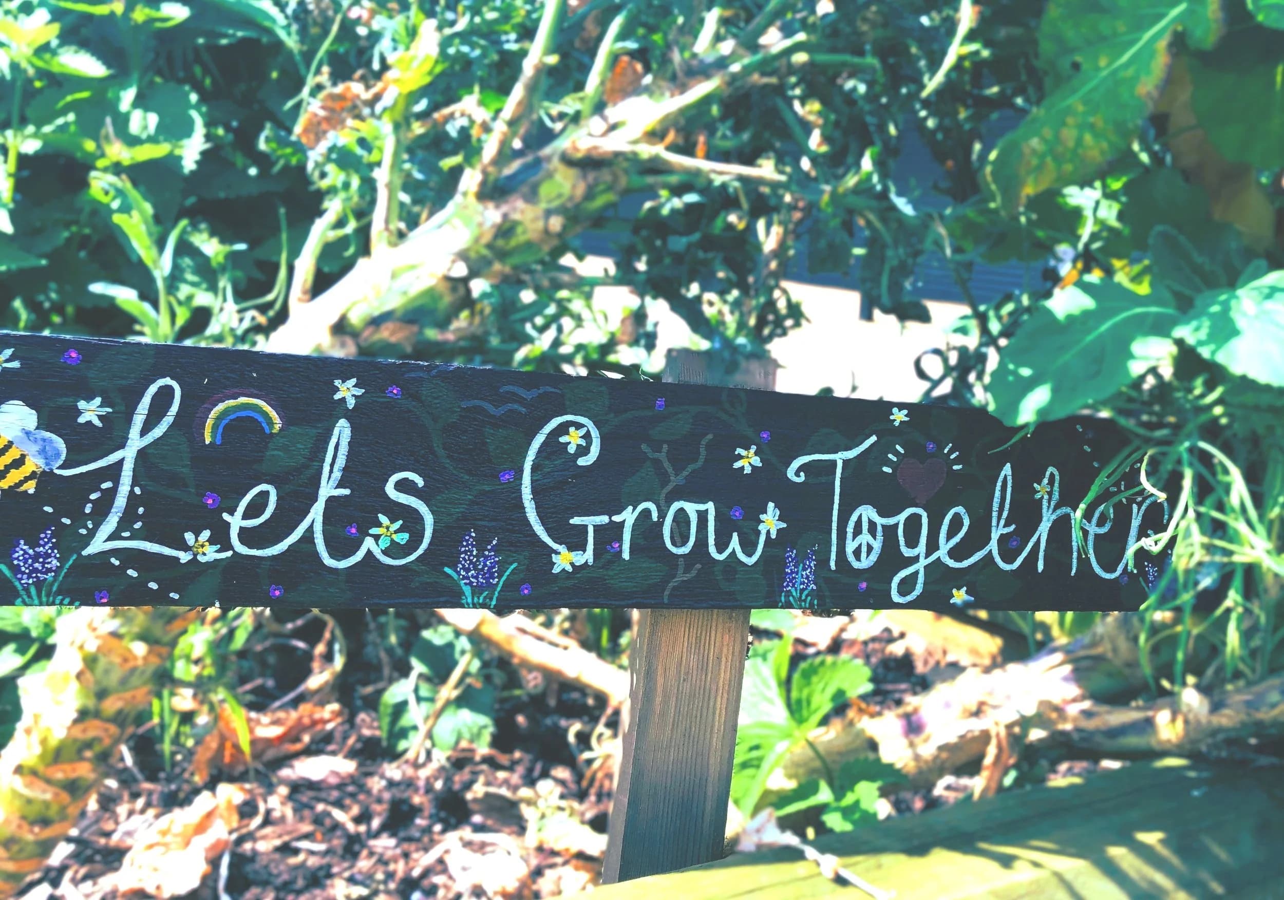 Let's grow together sign in a garden